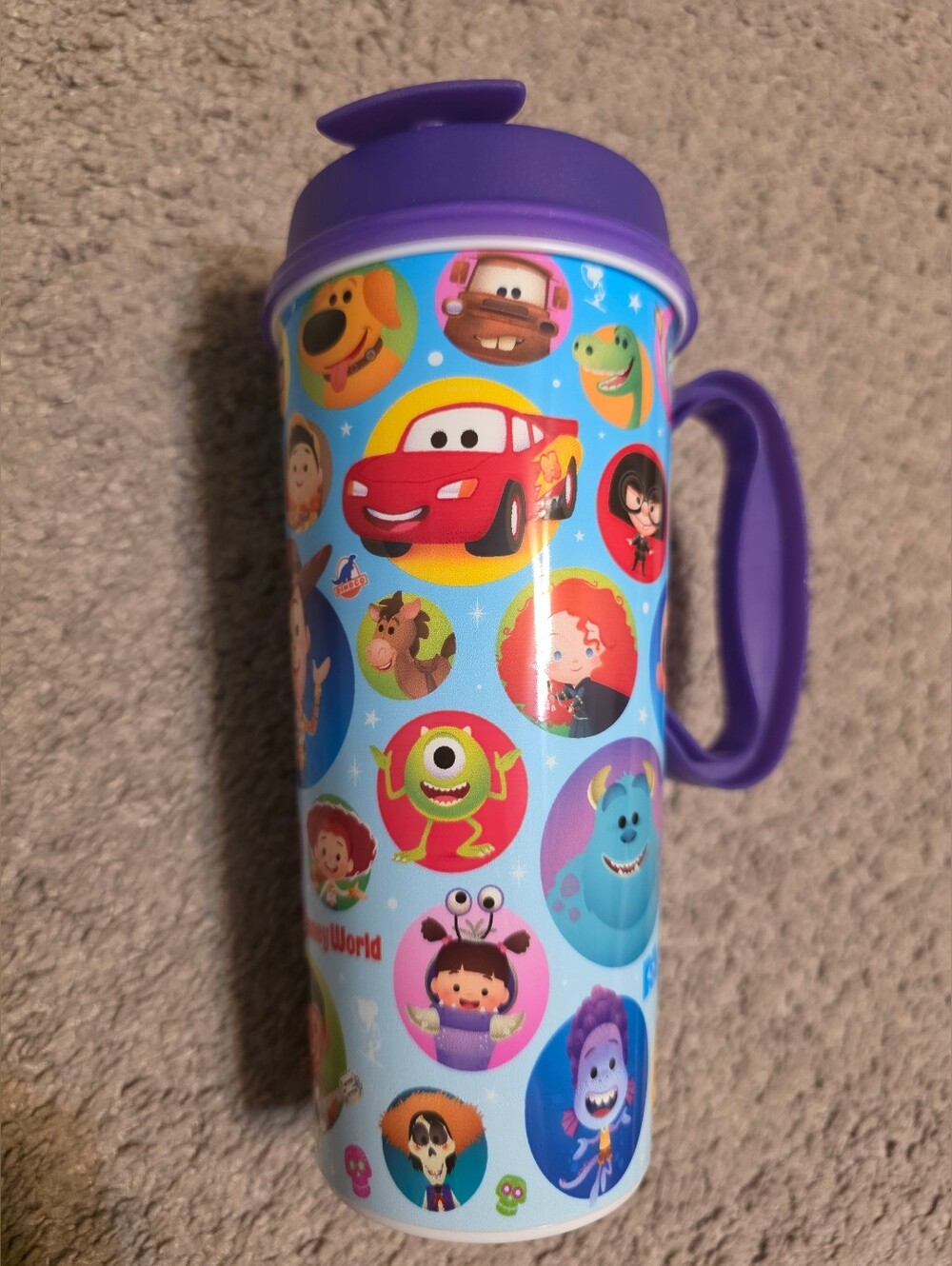 Walt Disney World Resort Pixar-themed refillable 16oz mug with a purple lid
